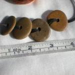 Drilled pebble beads from t..