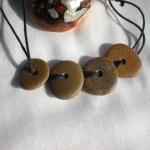 Drilled pebble beads from t..