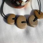 Drilled pebble beads from t..