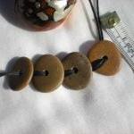 Drilled pebble beads from t..