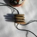 Drilled pebble beads from t..